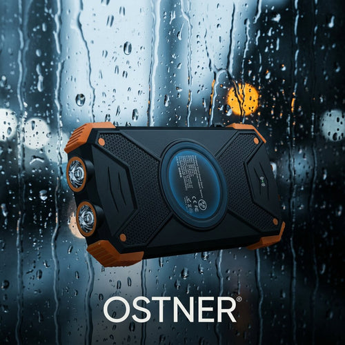 Back of the OSTNER power bank showing the wireless charging pad and dual LED flashlights against a rain-streaked window